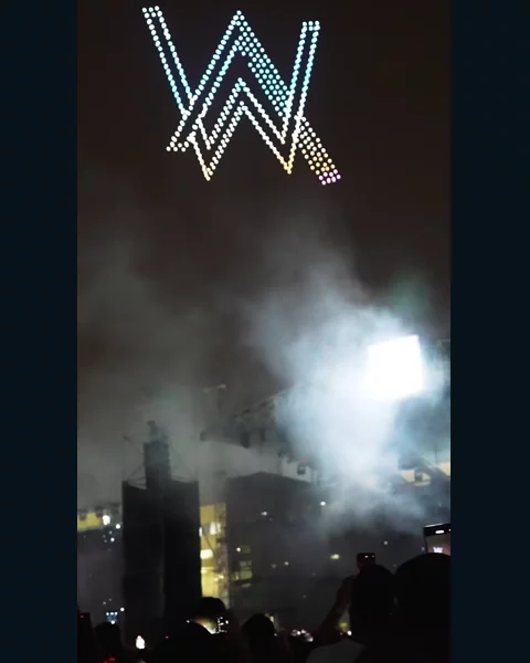 The AW logo formed by drones at an Alan Walker event
