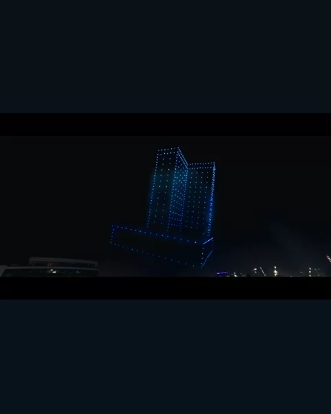 A building formation made of drone lights at the Binghatti show