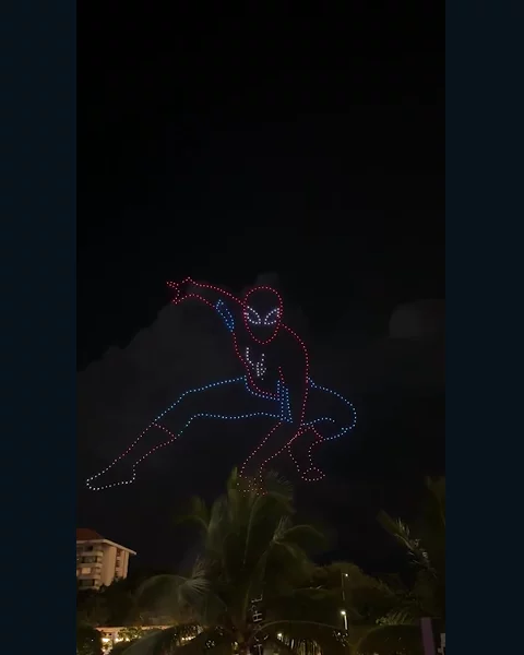 Spider-Man outlined in red and blue drone lights